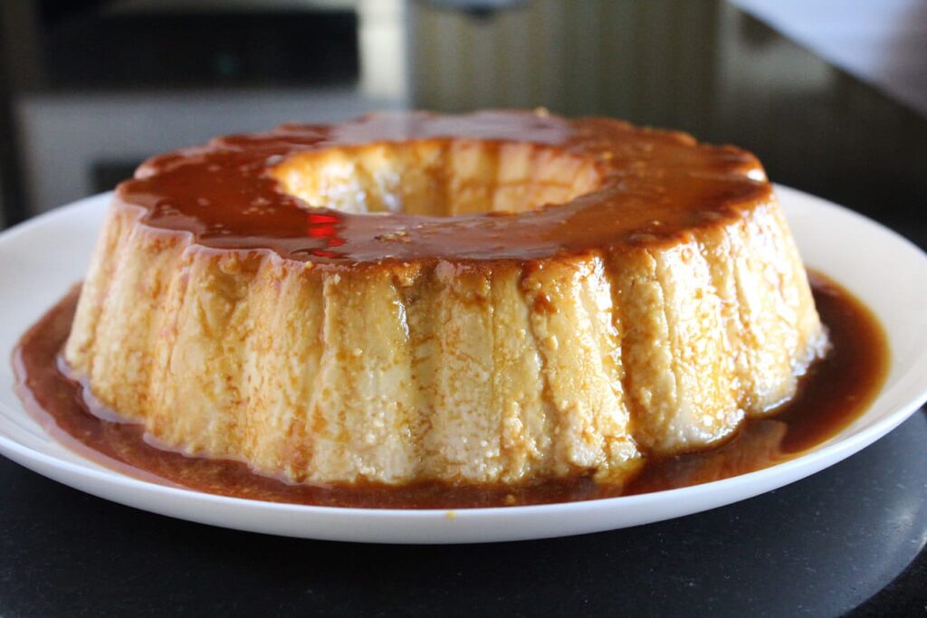 Side perspective showcasing the caramel glaze of the classic creme caramel.