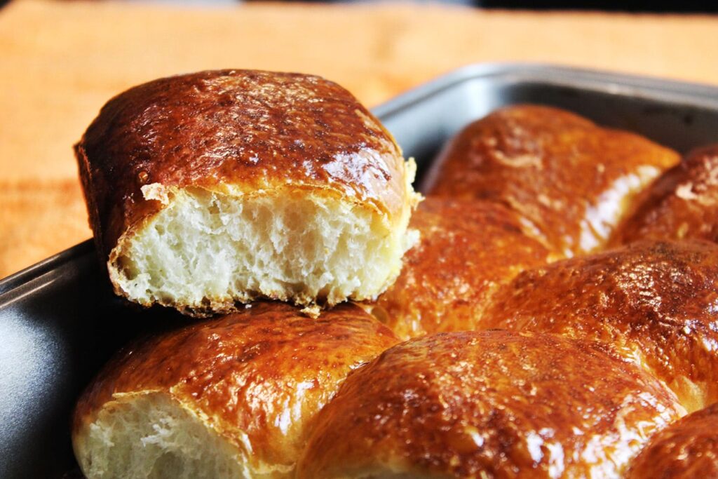 Side perspective displaying the rise and pull-apart structure of the fluffy hawaiian bread buns.