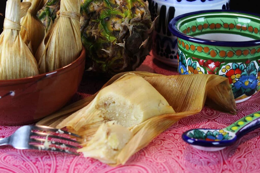 Side perspective showing the steamed texture of the opened pineapple mexican tamales.