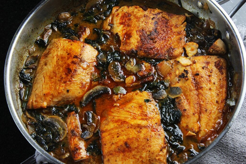 Side perspective displaying the thick creamy sauce over the coconut braised salmon.