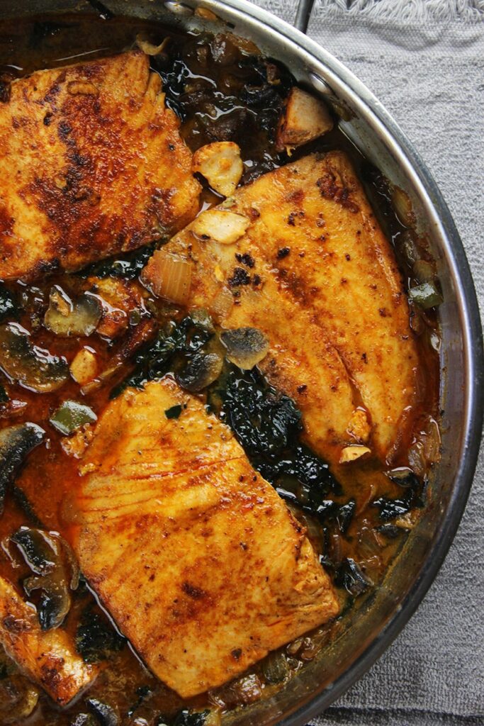 Seared salmon with coconut, chile, spinach and mushrooms