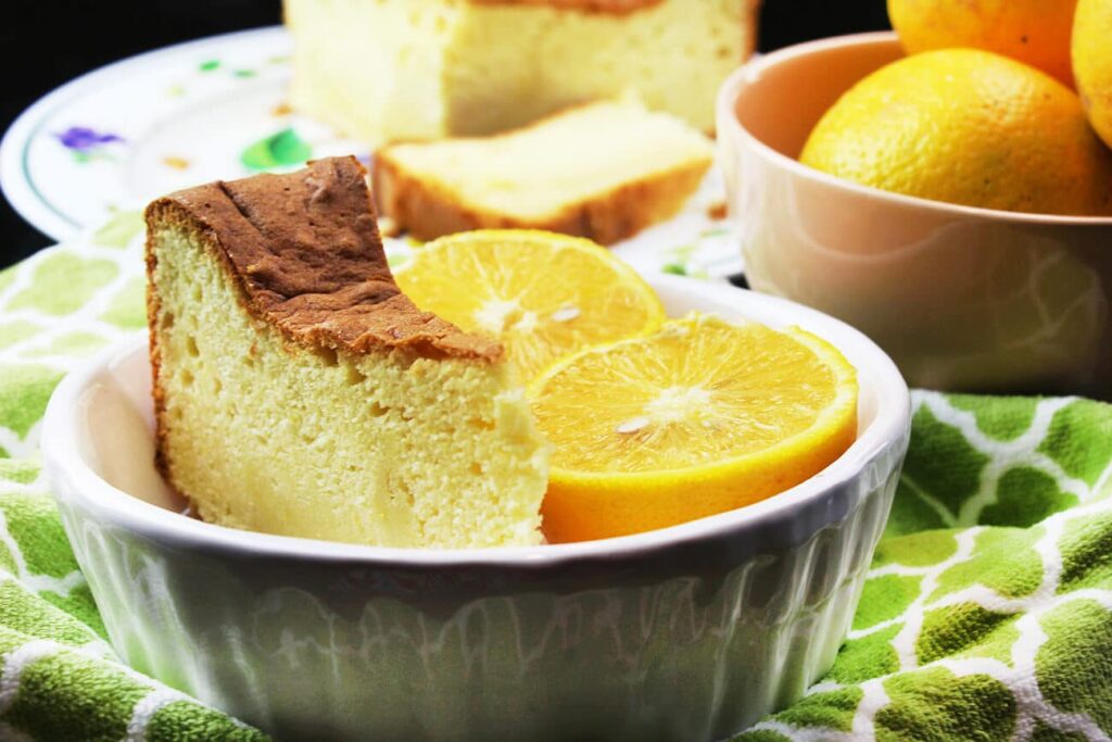 Side perspective highlighting the height of the orange pound cake slice.