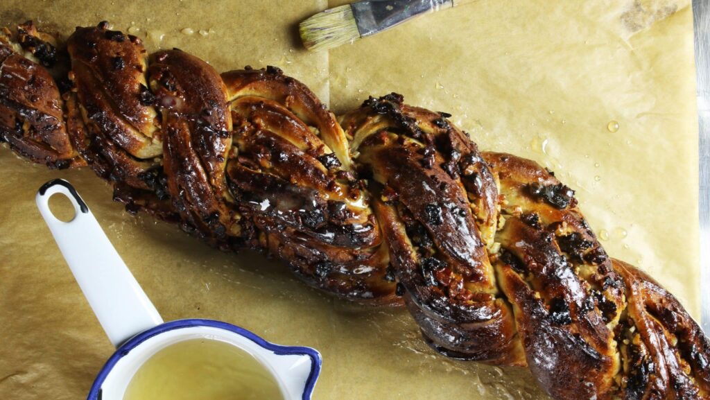Cropped overhead view displaying the baked golden crust of the honey bread loaf.