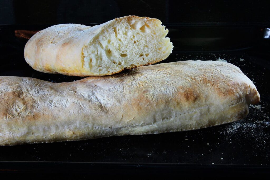 Side perspective displaying the flour-dusted outer layer of the no knead ciabatta loaf.