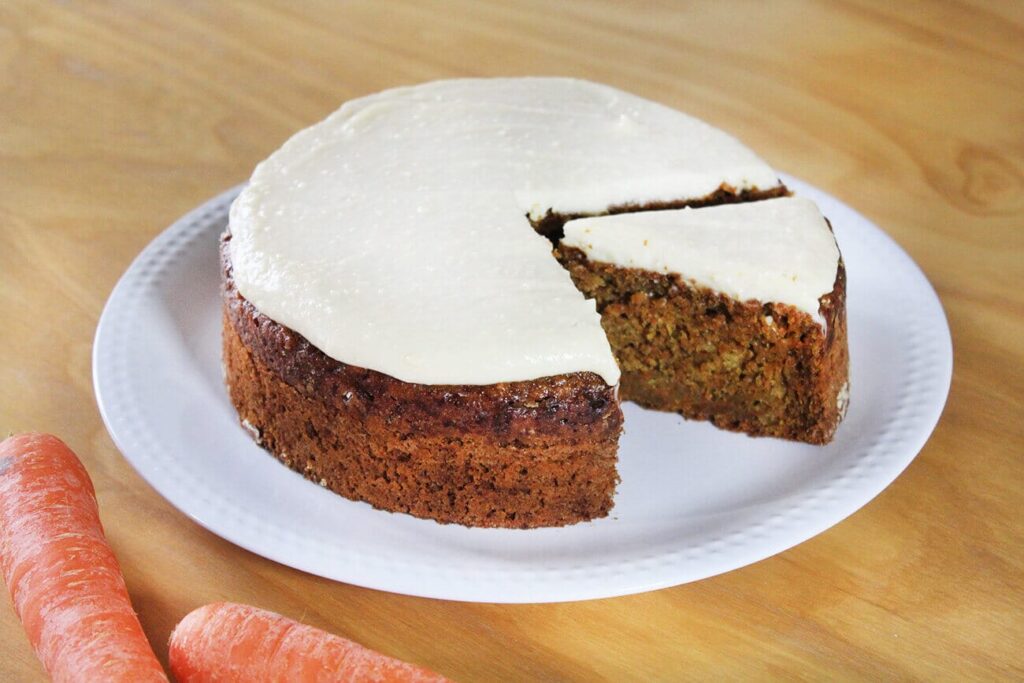 Side perspective showing the moist crumb layers of the healthy carrot cake recipe.