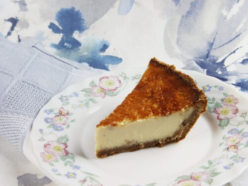 Side perspective displaying the biscuit base and thick filling of the Mexican cheesecake.