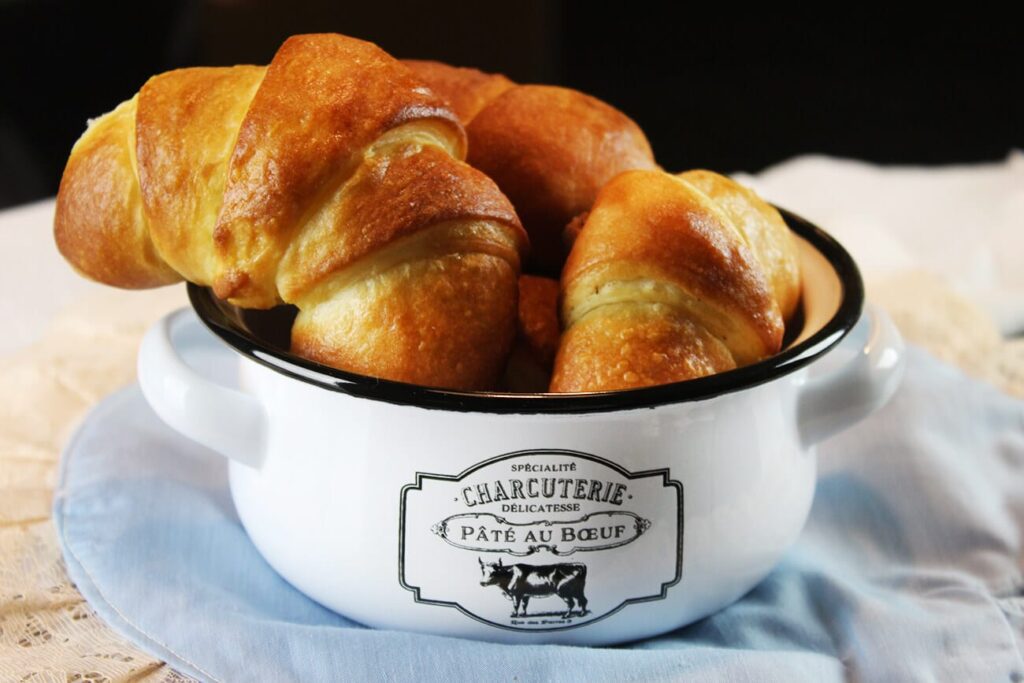 Side perspective displaying the flaky pastry layers of the cooked nutella crescent rolls.