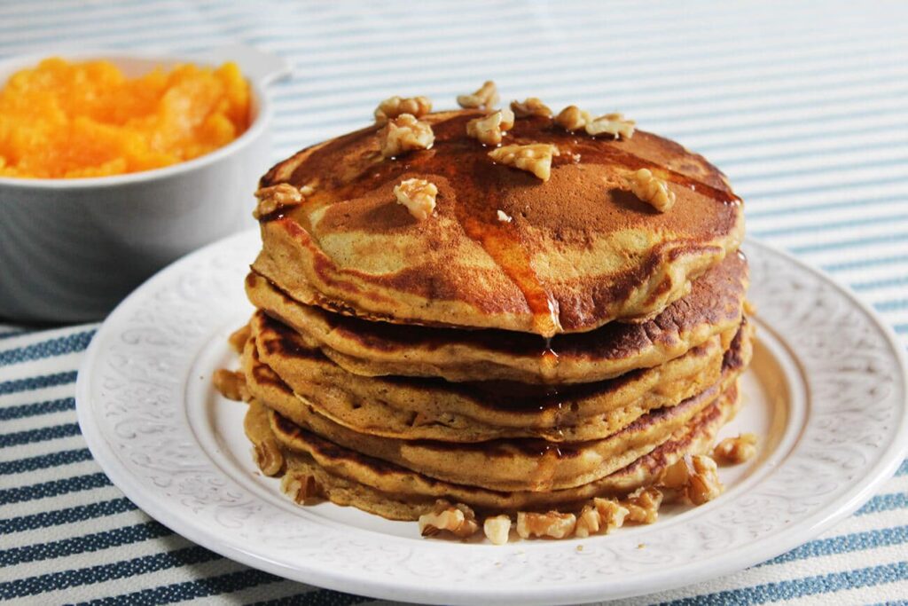 Pumpkin pancakes with maple syrup and pecan nuts