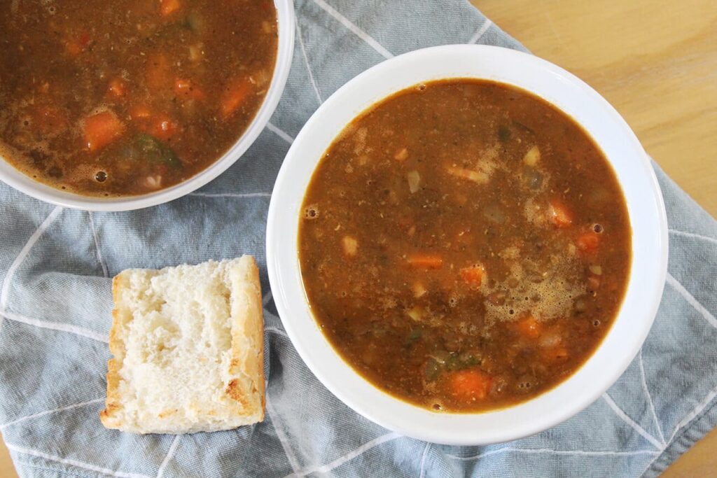 Overhead view showing a warm bowl filled with savory lentil soup recipe.
