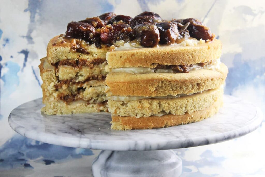Side perspective showing the layers and crumb of the vegan date vanilla cake.