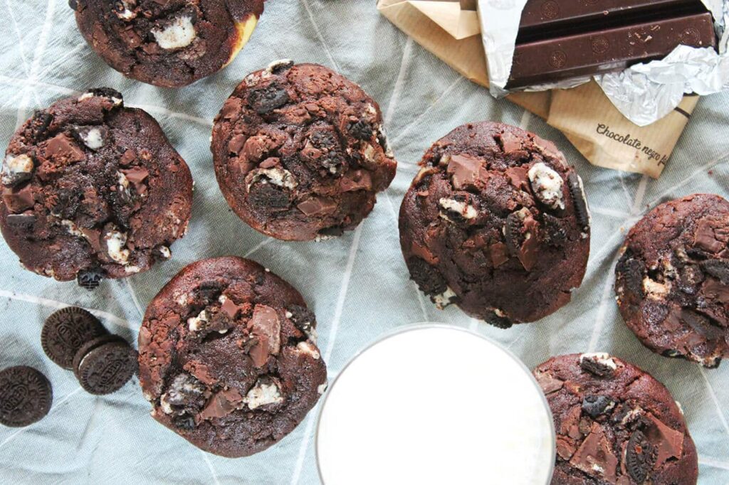 Close-up overhead view focusing on the top of the chocolate oreo muffins with cream cheese filling.