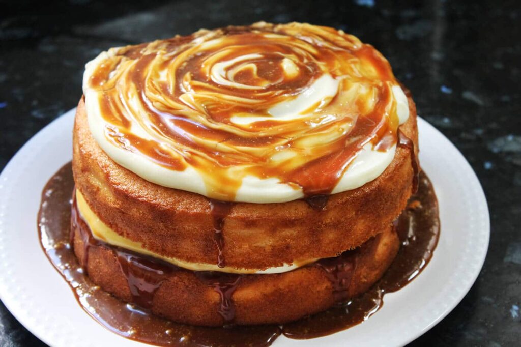 Side perspective showing the moist crumb and layers of the caramel cake.