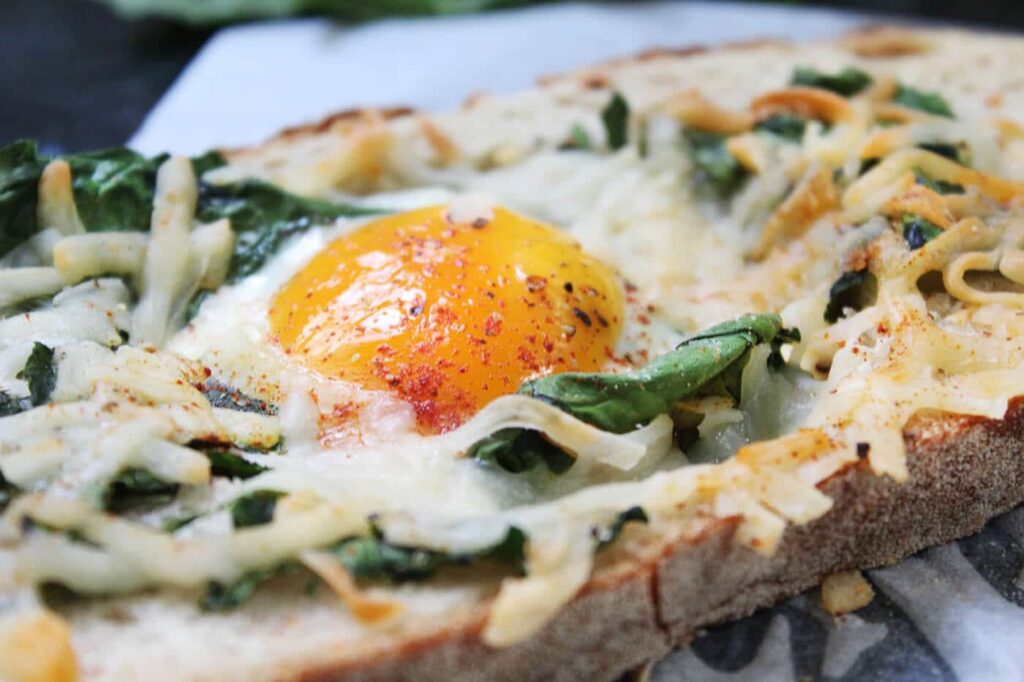 Spinach egg in a hole with melted cheese