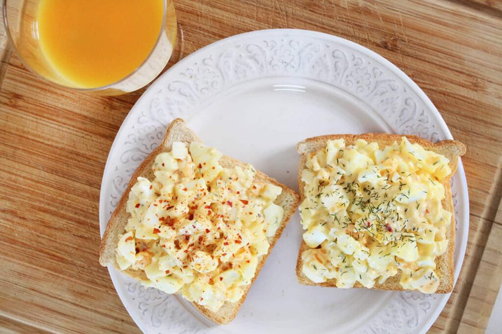 Overhead perspective looking down into the fresh garnished bowl of classic egg salad.