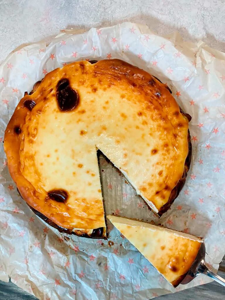 Overhead view showing the signature dark caramelized surface of the large Basque cheesecake.