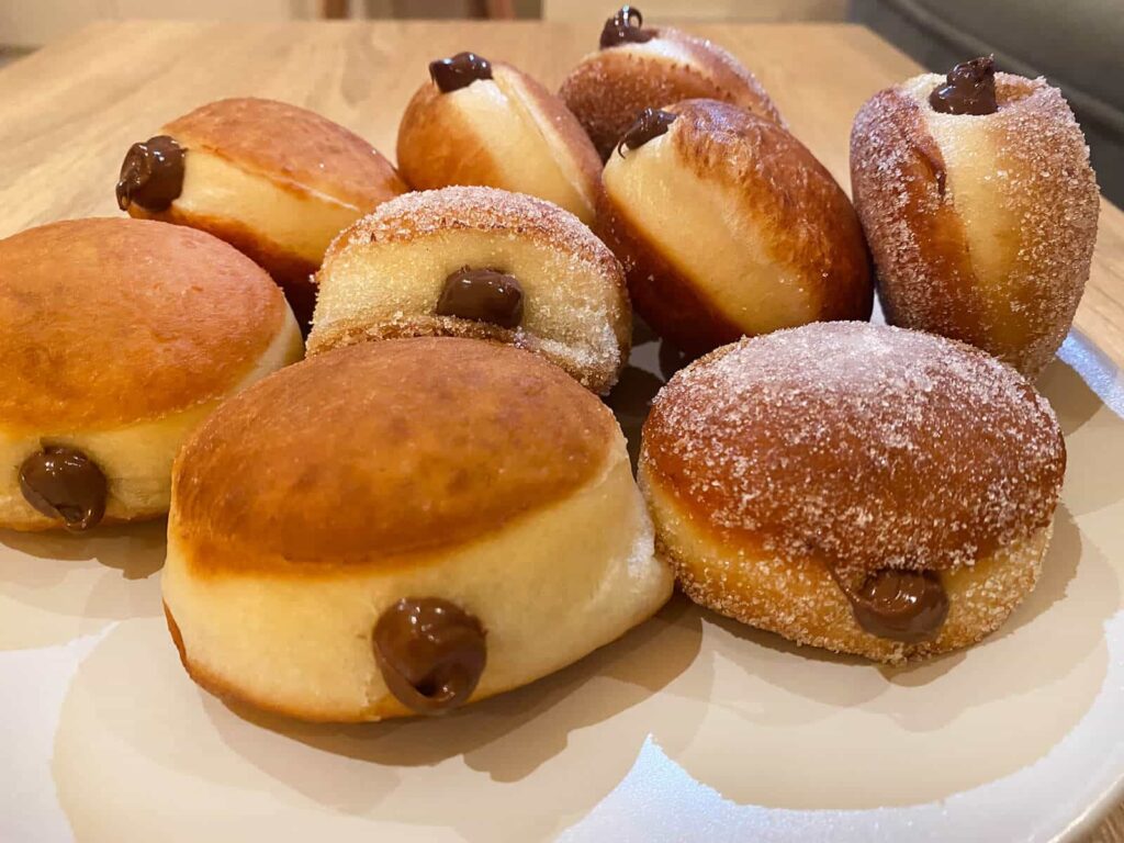Side perspective showing the plump airy dough structure and thickness of the nutella bomboloni.