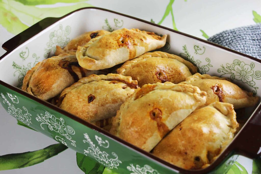 Side perspective displaying the shape and bake of the Argentinian beef empanadas.