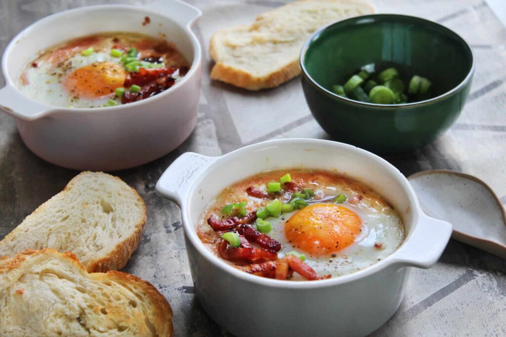 How to make eggs en cocotte with tomato bacon and cheese