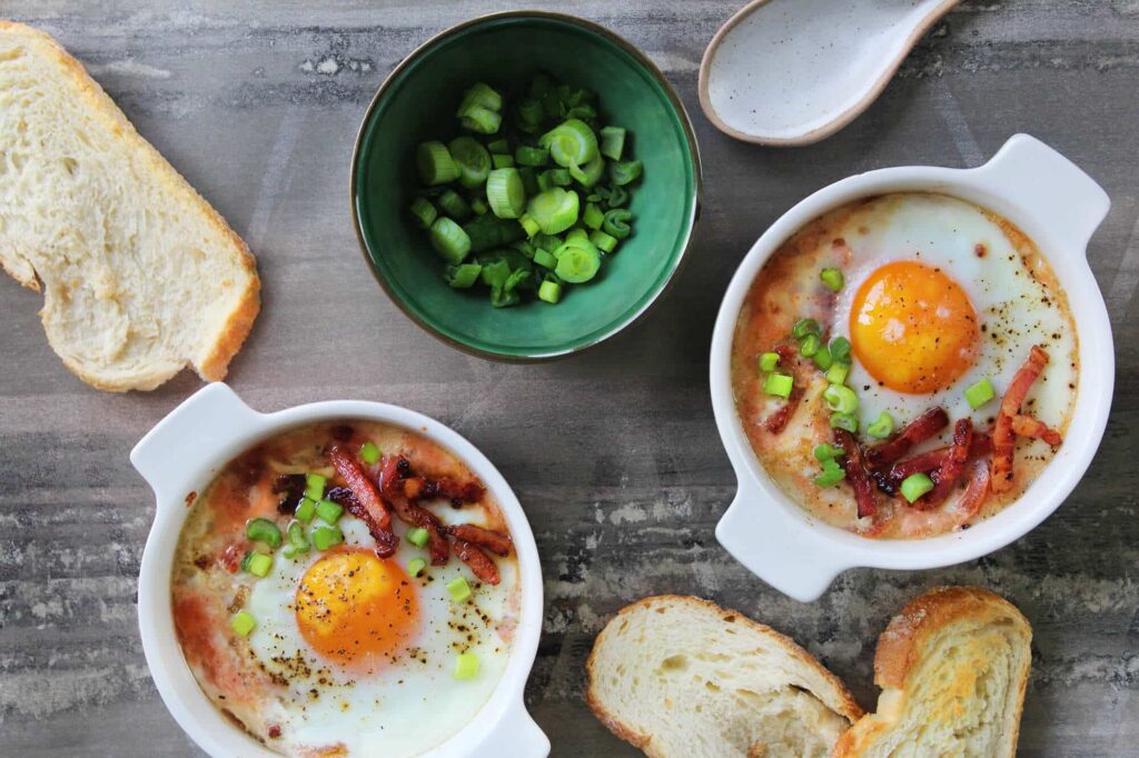 Eggs en cocotte with tomato bacon and cheese