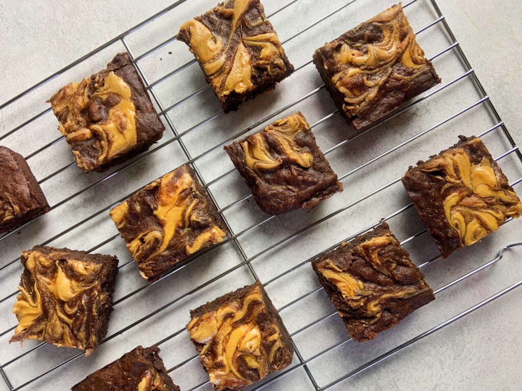 Presentation of the full sliced batch of scaled rich peanut butter banana brownies.