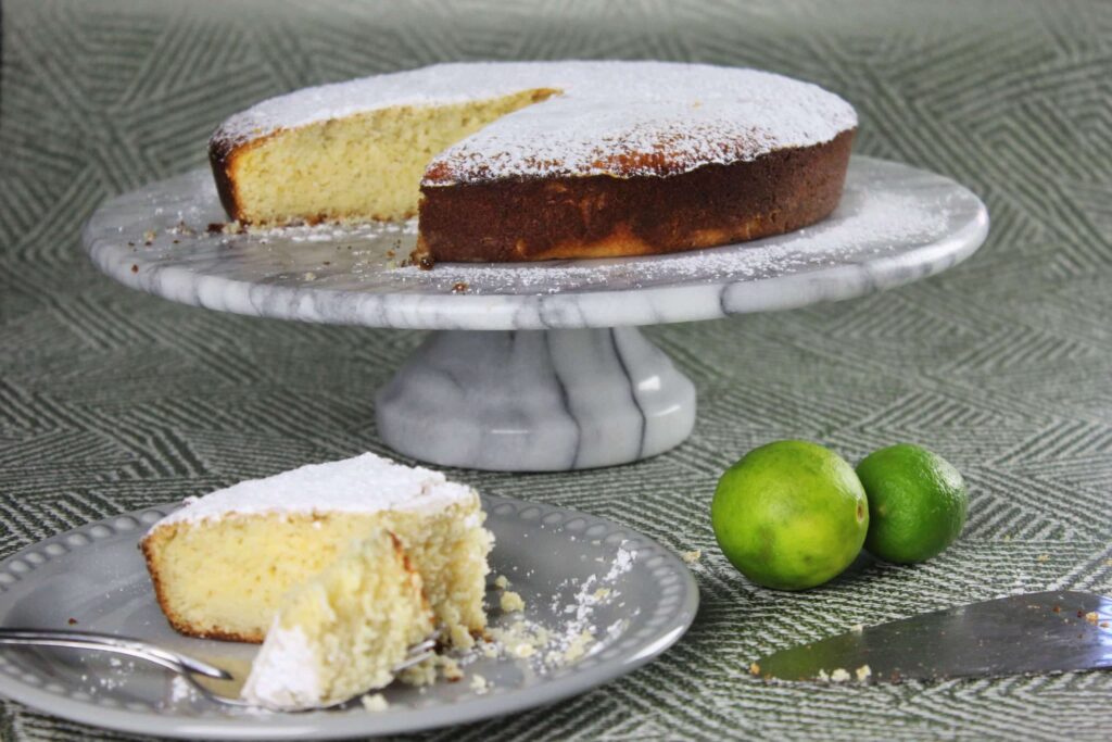 Scaled presentation of the complete whole round Italian lemon ricotta cake ready to serve.