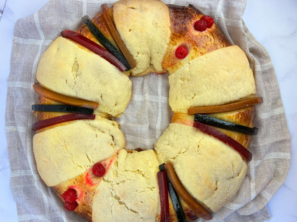 Overhead view displaying the large oval layout of the scaled whole three kings day bread.