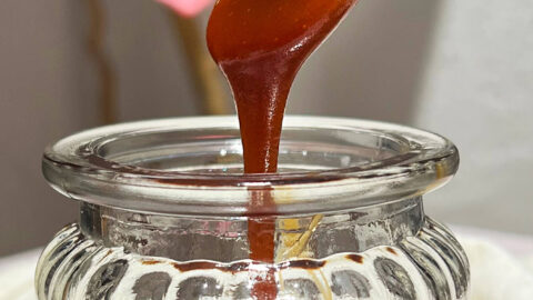 Close-up shot showing the thick stream of the poured best caramel sauce.